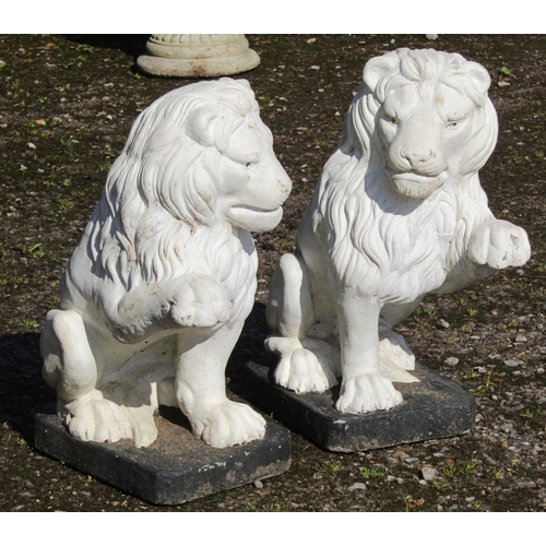 212 - A pair of painted cast composition stone garden ornaments/pier finials in the form of seated lions w... 