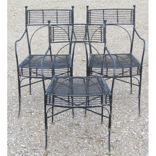 216 - A set of three heavy gauge iron work garden open armchairs with x framed stretchers