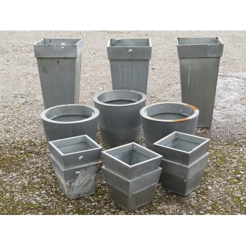 222 - Twelve contemporary but weathered tin planters of varying size and design