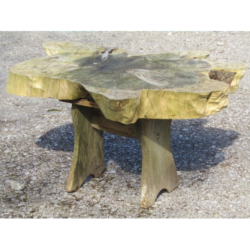 229 - A rustic wooden garden table raised on shaped supports, approximately one metre long x 80 cm wide x ... 