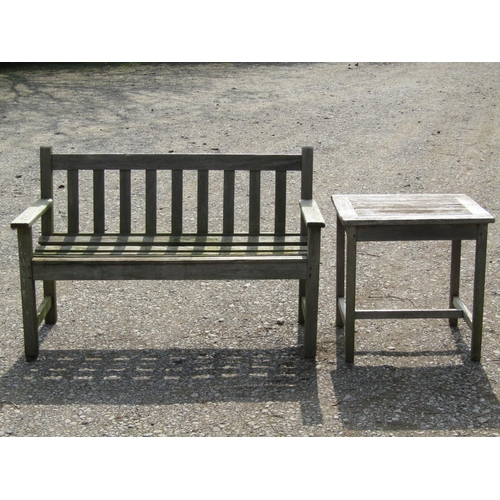 230 - A Jonelle weathered teak two seat garden bench with slatted seat and back, 124 cm wide together with... 