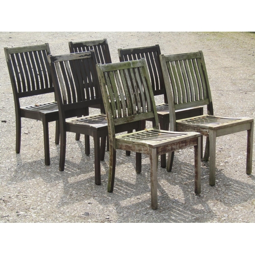 231 - A set of six stained and weathered Gloster teak garden chairs with slatted seats and backs (capable ... 