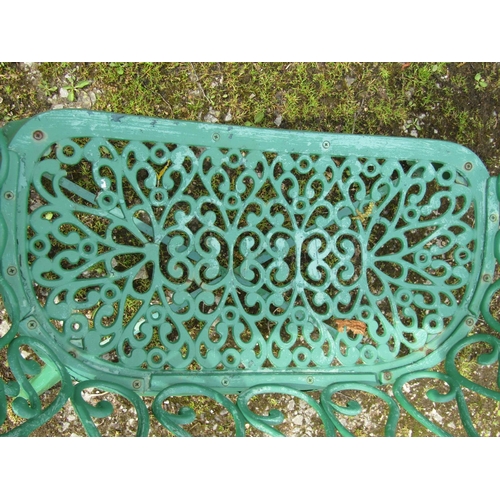 234 - A small decorative green painted cast iron garden bench with repeating pierced open scroll foliate p... 