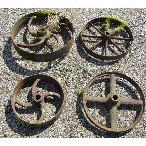 239 - Four antique cast iron implement wheels of varying size and design, the largest example 53 cm in dia... 