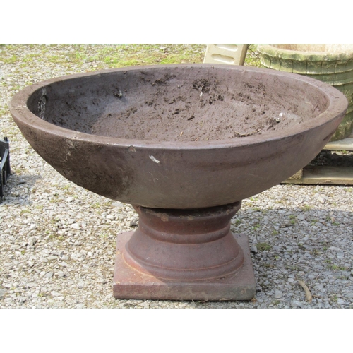 249 - A large matt glazed terracotta planter with circular shallow bowl raised on a loose socle, 90 cm dia... 