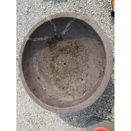 249 - A large matt glazed terracotta planter with circular shallow bowl raised on a loose socle, 90 cm dia... 