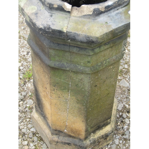 84 - A weathered buff coloured octagonal chimney pot together with a further cylindrical example (2) (af)