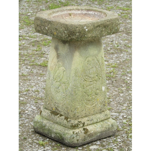 90 - A weathered cast composition stone two sectional bird bath with repeating oval bird and branch panel... 