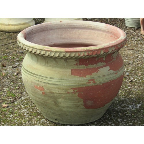 248 - A large weathered light green painted terracotta circular planter with banded detail, 64 cm diameter... 