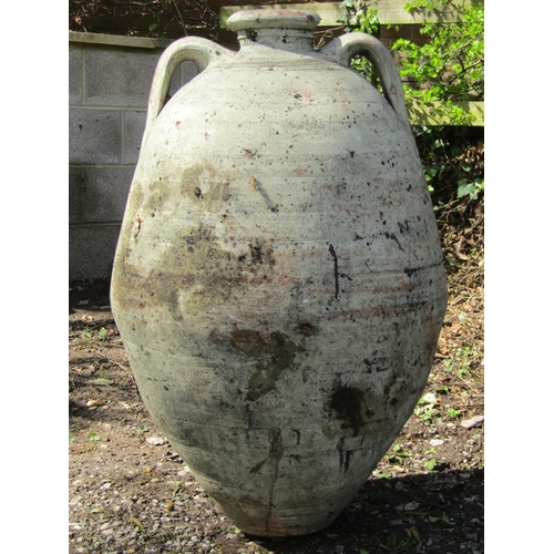 220 - Two similar weathered buff coloured terracotta jars with moulded loop handles and incised collars (a... 