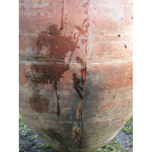 221 - Two similar weathered terracotta jars with reeded collars (af) slight variation in height, the large... 