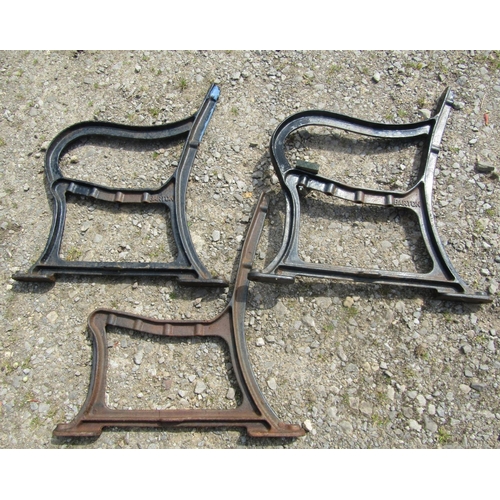 117 - A pair of heavy gauge cast iron bench ends and central support, with shaped outline, stamped Barton ... 