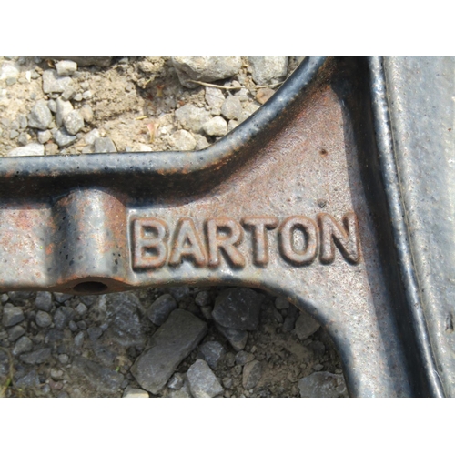 117 - A pair of heavy gauge cast iron bench ends and central support, with shaped outline, stamped Barton ... 