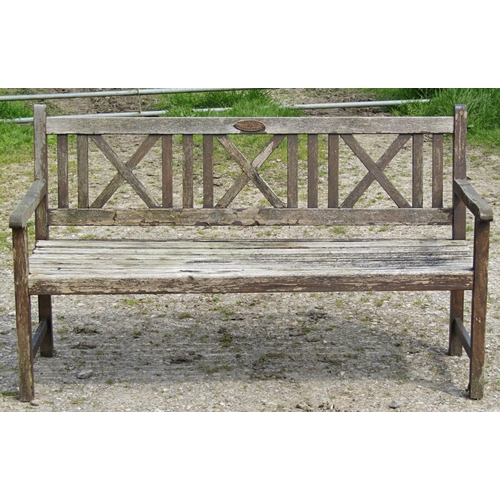 99 - A Claire Collection weathered hardwood three seat garden bench with slatted seat and X framed panell... 