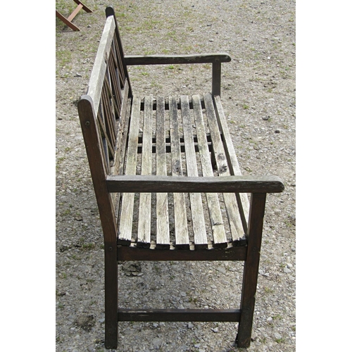 99 - A Claire Collection weathered hardwood three seat garden bench with slatted seat and X framed panell... 