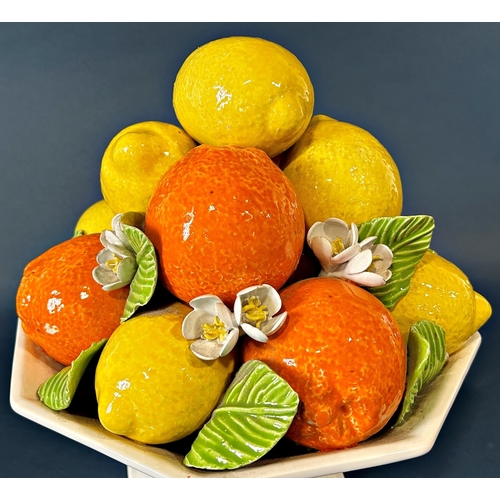 2017 - An Italian porcelain table centre in the form of an octagonal basket laden with oranges and lemons