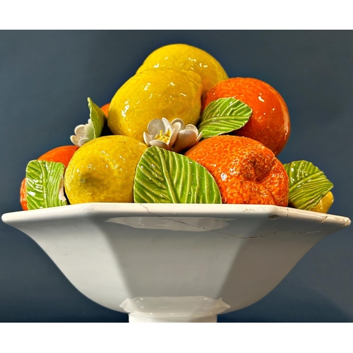 2017 - An Italian porcelain table centre in the form of an octagonal basket laden with oranges and lemons