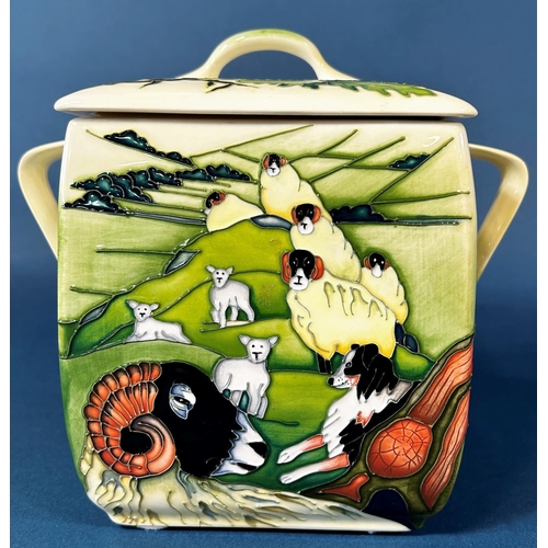 2039 - A Moorcroft Swales dale Biscuit jar and cover with loop handles, decorated to all sides of sheep in ... 