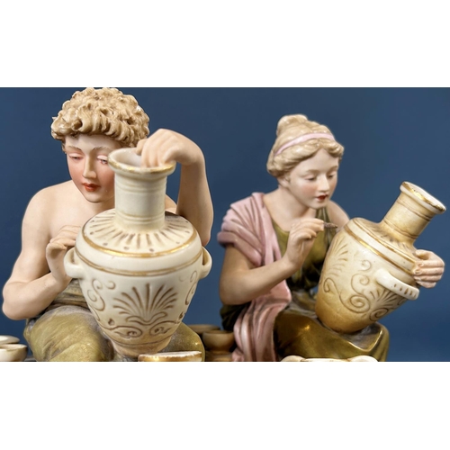 2046 - A pair of Royal Dux figures of male and female characters decorating ceramic pots