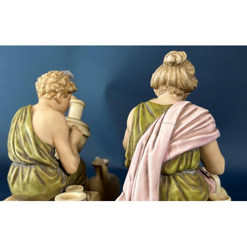 2046 - A pair of Royal Dux figures of male and female characters decorating ceramic pots