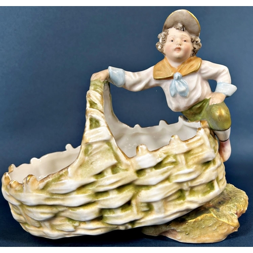 2047 - A Royal Dux basket surmounted by a young boy, further Italian group of an old knife grinder