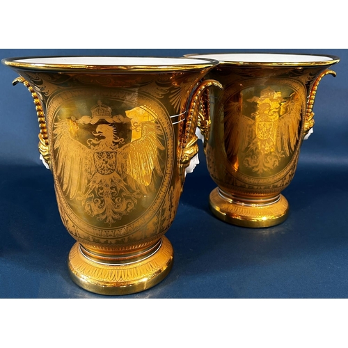 2070 - A pair of brush vases in a white and gilt colourway with spread eagle, acanthus, facial mask and oth... 