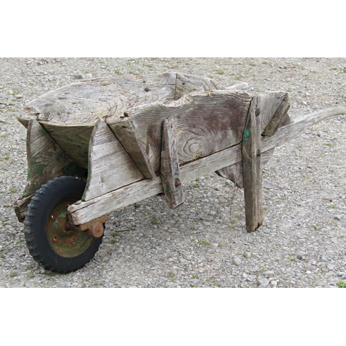 185 - A weathered traditional elm wheelbarrow with possibly later replaced wheel (af) together with a smal... 