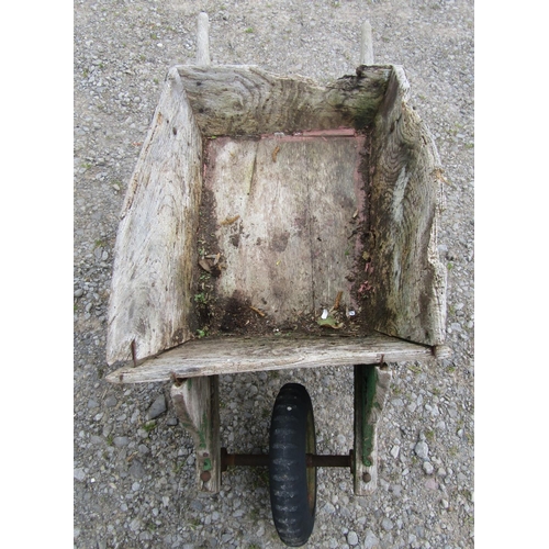 185 - A weathered traditional elm wheelbarrow with possibly later replaced wheel (af) together with a smal... 