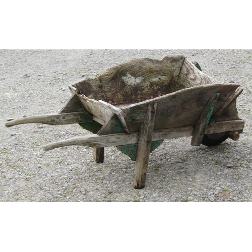 185 - A weathered traditional elm wheelbarrow with possibly later replaced wheel (af) together with a smal... 