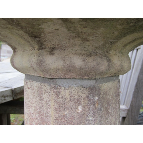 199 - A weathered cast composition stone two sectional bird table of octagonal form with simulated tiled r... 