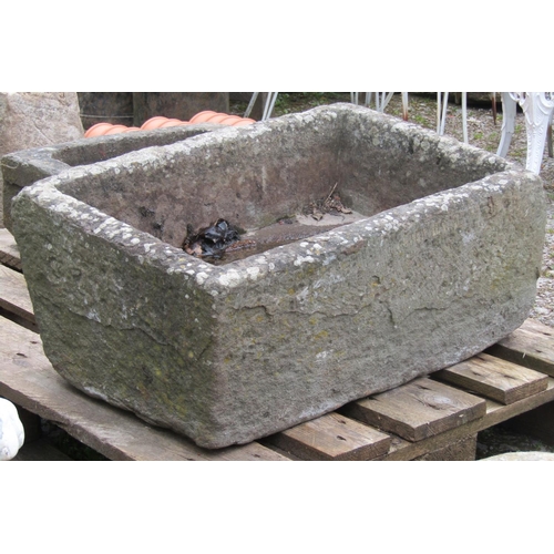 209 - A weathered natural stone trough 67 cm long x 43 cm wide x 32 cm high (slightly tapered)