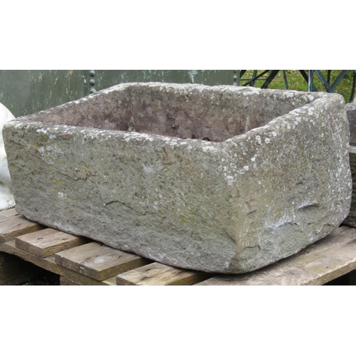 209 - A weathered natural stone trough 67 cm long x 43 cm wide x 32 cm high (slightly tapered)