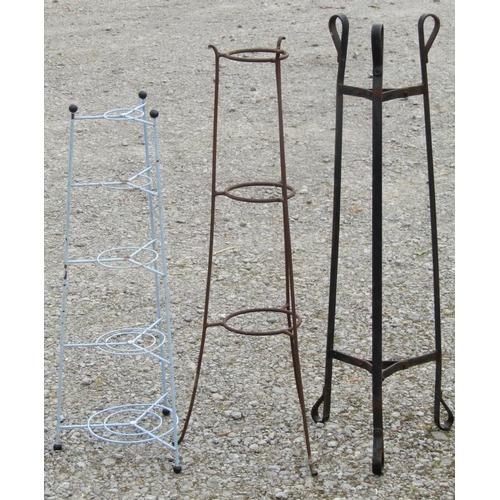 214 - Three iron work stands of varying design and purpose, the tallest example one metre high