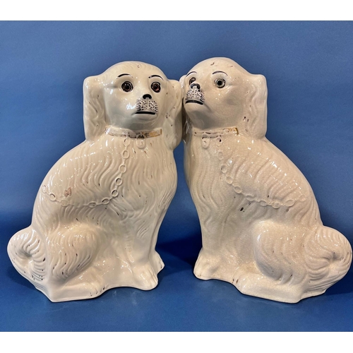 2110 - A pair of large 19th century Staffordshire spaniels in a white and gilt colourway