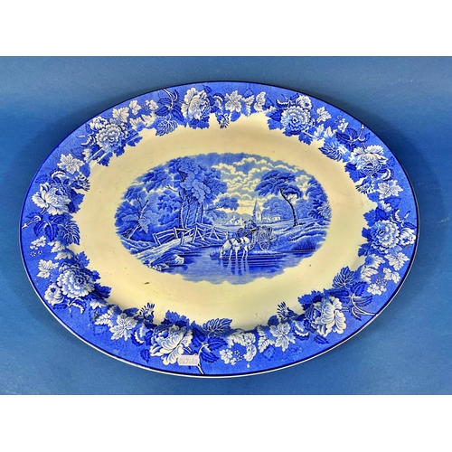 2116 - A large blue and white meat plate with landscape detail, a further 19th century meat plate with grav... 