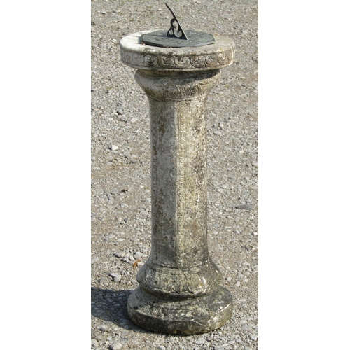 178 - A weathered octagonal sun dial with pierced gnomon set on a composition stone pedestal with relief d... 