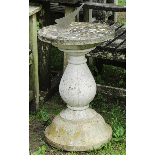 98 - A weathered cast composition stone two sectional sundial of circular form, raised on a baluster pede... 