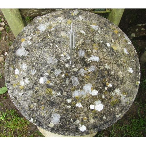 98 - A weathered cast composition stone two sectional sundial of circular form, raised on a baluster pede... 