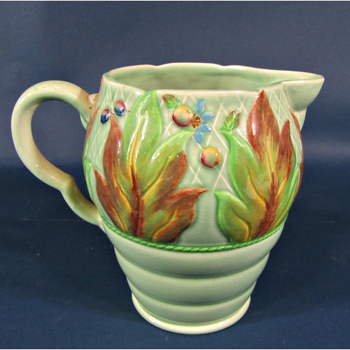 2089 - A Clarice Cliff jug with stylised embossed floral detail on a ribbed and tapered base