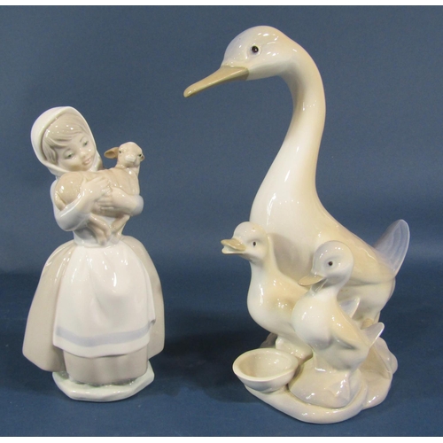 2104 - A collection of Lladro/Nao type figurines to include a girl feeding birds, three geisha girls, a whi... 