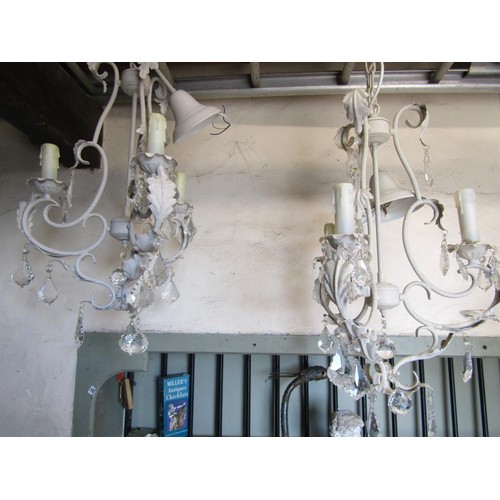 3032 - A contemporary eight branch cream painted light metal chandelier with moulded glass stem and faceted... 