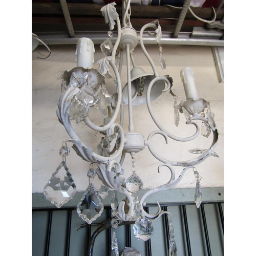 3032 - A contemporary eight branch cream painted light metal chandelier with moulded glass stem and faceted... 