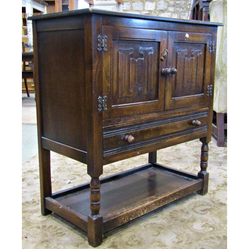 3105 - Reproduction old English style low oak side cupboard enclosed by a pair of linen fold panelled doors... 