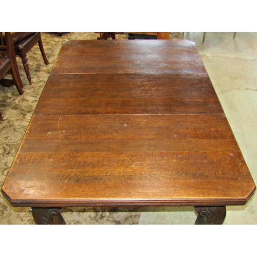 3101 - Edwardian oak wind out extending dining table, the rectangular top with moulded outline, canted corn... 