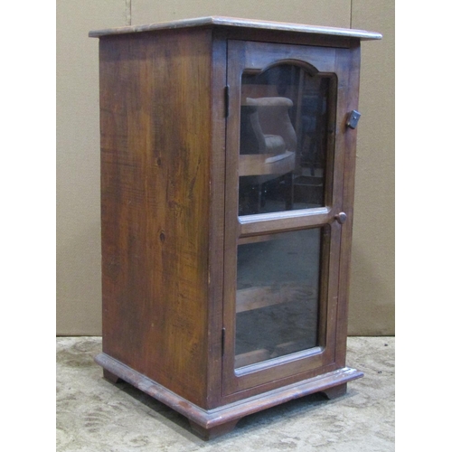 3112 - Low hardwood side cabinet enclosed by a moulded glazed panelled door, with wine rack to interior, to... 