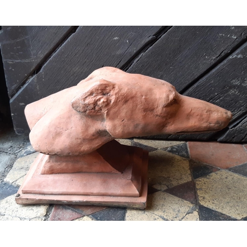 3006 - A pair of moulded greyhound heads with a terracotta finish