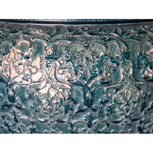 3030 - A large 19th century glazed jardinière with repeating geometric detail and turquoise glaze, raised o... 