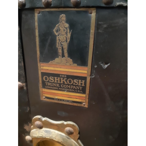 3043 - A vintage Oshkosh travelling trunk (Wisconsin USA) with steel banded riveted borders, with patent da... 