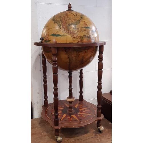 3044 - A cocktail cabinet in the form of a globe on turned supports, a nest of three graduated oak occasion... 