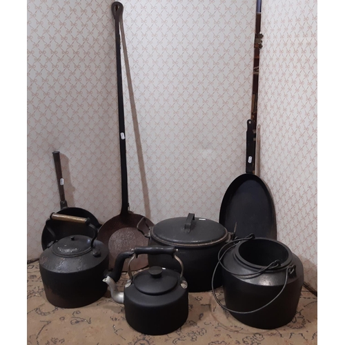 3058 - A heavy iron kettle, glue pot, casserole and cover, out sized ladle, etc